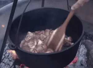 Using Dutch oven in outdoor cooking.